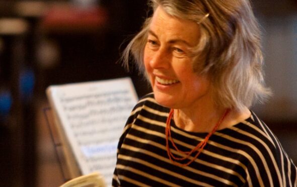 Gudrun Edwards smiling whilst taking applause at a Kew Sinfonia concert in 2010