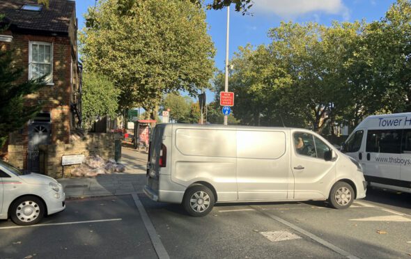 Cars queuing to drive onto the main A316 from the side street Raleigh Road but blocked by vehicles on the main road