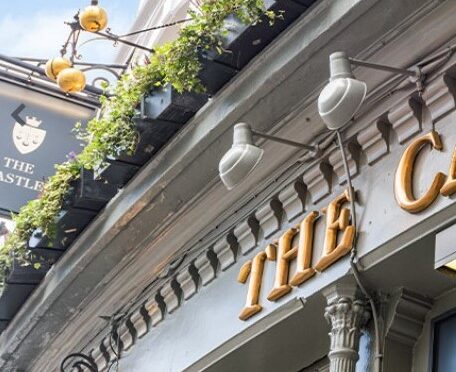 Exterior of the Castle Pub showing pawnbroker sign