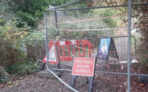 Thames towpaths with metal barriers across and signs saying "Flood" and "Footway Closed"