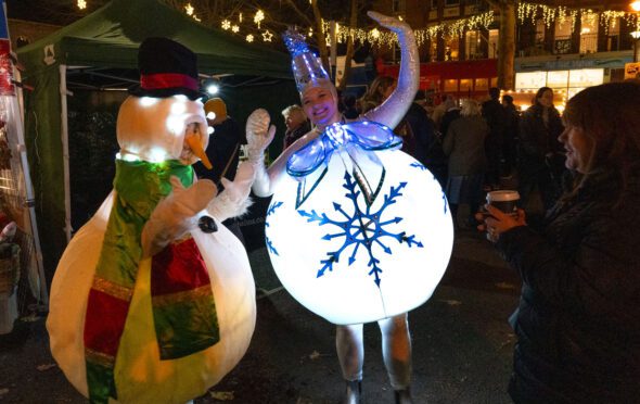 Image from Kew Sparkle showing two young women dressed as Christmas tree decorations